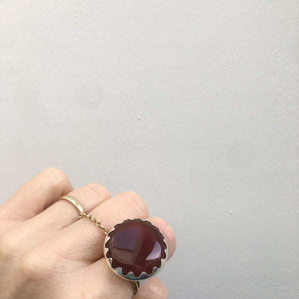 carnelian gemstone ring set in a sterling silver setting - worn on hand