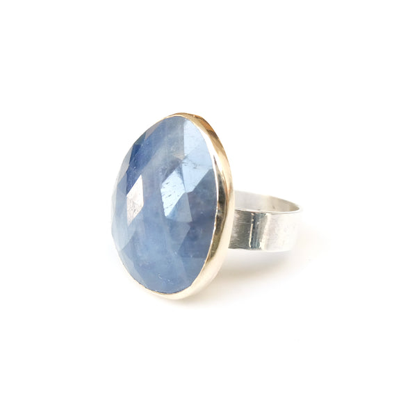 sapphire gemstone ring - faceted semi precious stone in a gold setting with silver ring - left side