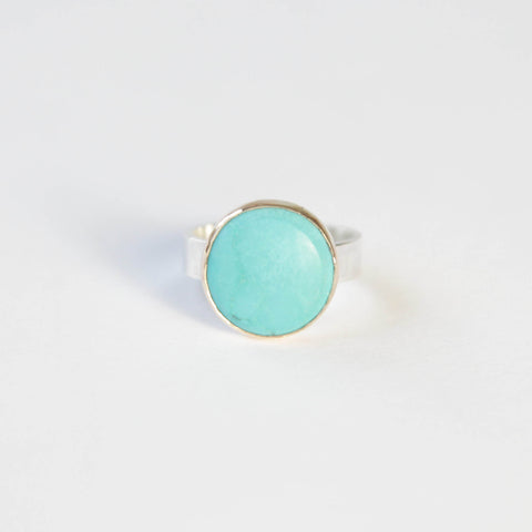 bright small turquoise gemstone ring set in 9ct gold with silver ring
