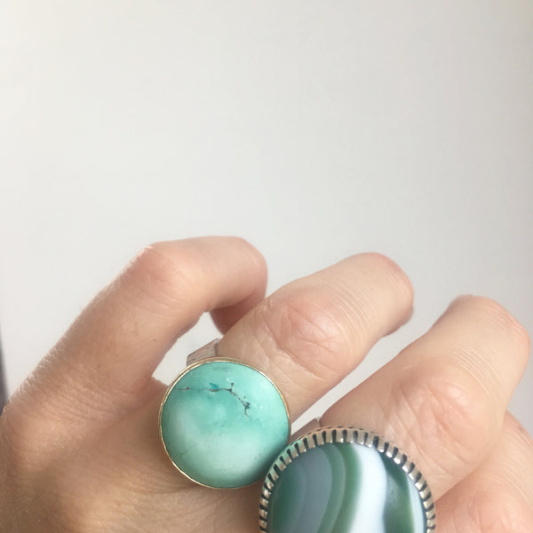 bright tibetan turquoise gemstone ring set in 9ct gold and sterling silver - worn on hand 