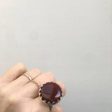 carnelian gemstone ring set in a sterling silver setting - worn on hand