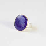 lapis lazuli gemstone ring set in gold with a silver ring
