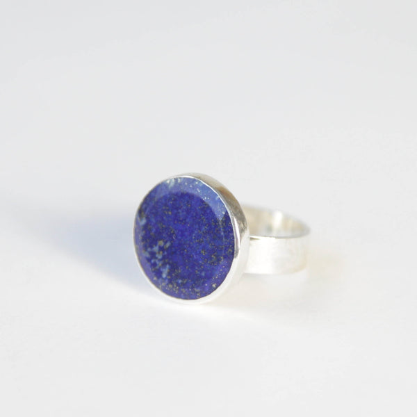 lapis lazuli flat cut gemstone ring set in gold with a sterling silver ring band - front left