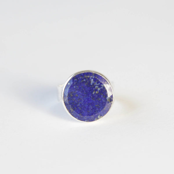 lapis lazuli flat cut gemstone ring set in gold with a sterling silver ring band