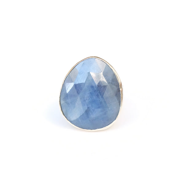 sapphire gemstone ring - faceted semi precious stone in a gold setting with silver ring - top view in light