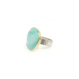 bright tibetan turquoise gemstone ring set in 9ct gold and sterling silver - front left